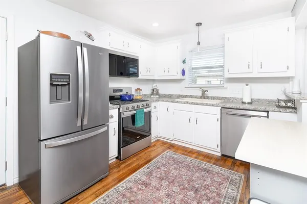 a kitchen with stainless steel appliances and wooden cabinets