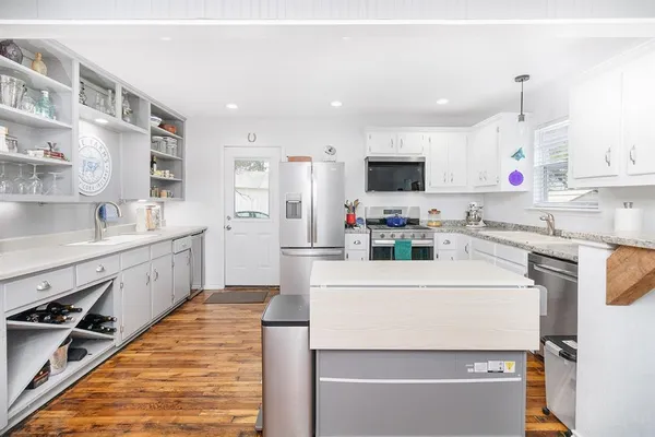 a kitchen with stainless steel appliances sink refrigerator and microwave