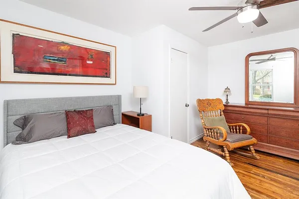 a bedroom with a bed and wooden floor