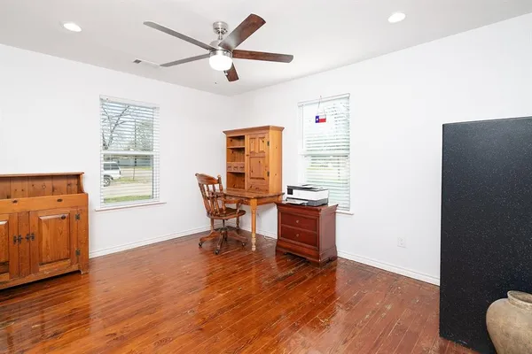 a view of a workspace with furniture and a window