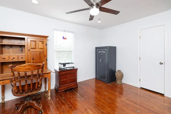 a bedroom with furniture and wooden floor