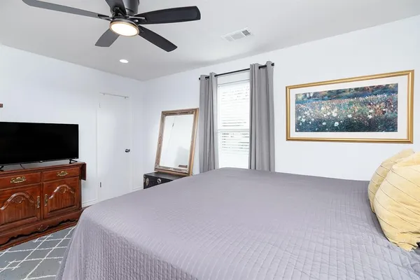 a bedroom with a bed and a flat screen tv