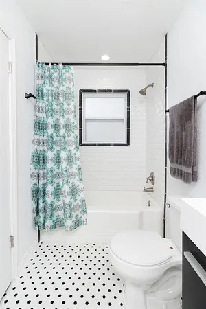 a bathroom with a toilet a sink and a shower