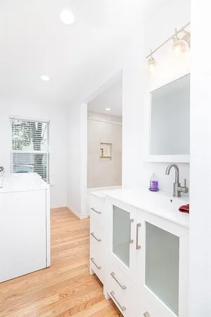 a bathroom with a sink a mirror and a bath tub