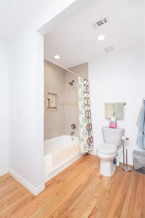 a bathroom with a bathtub toilet and a shower