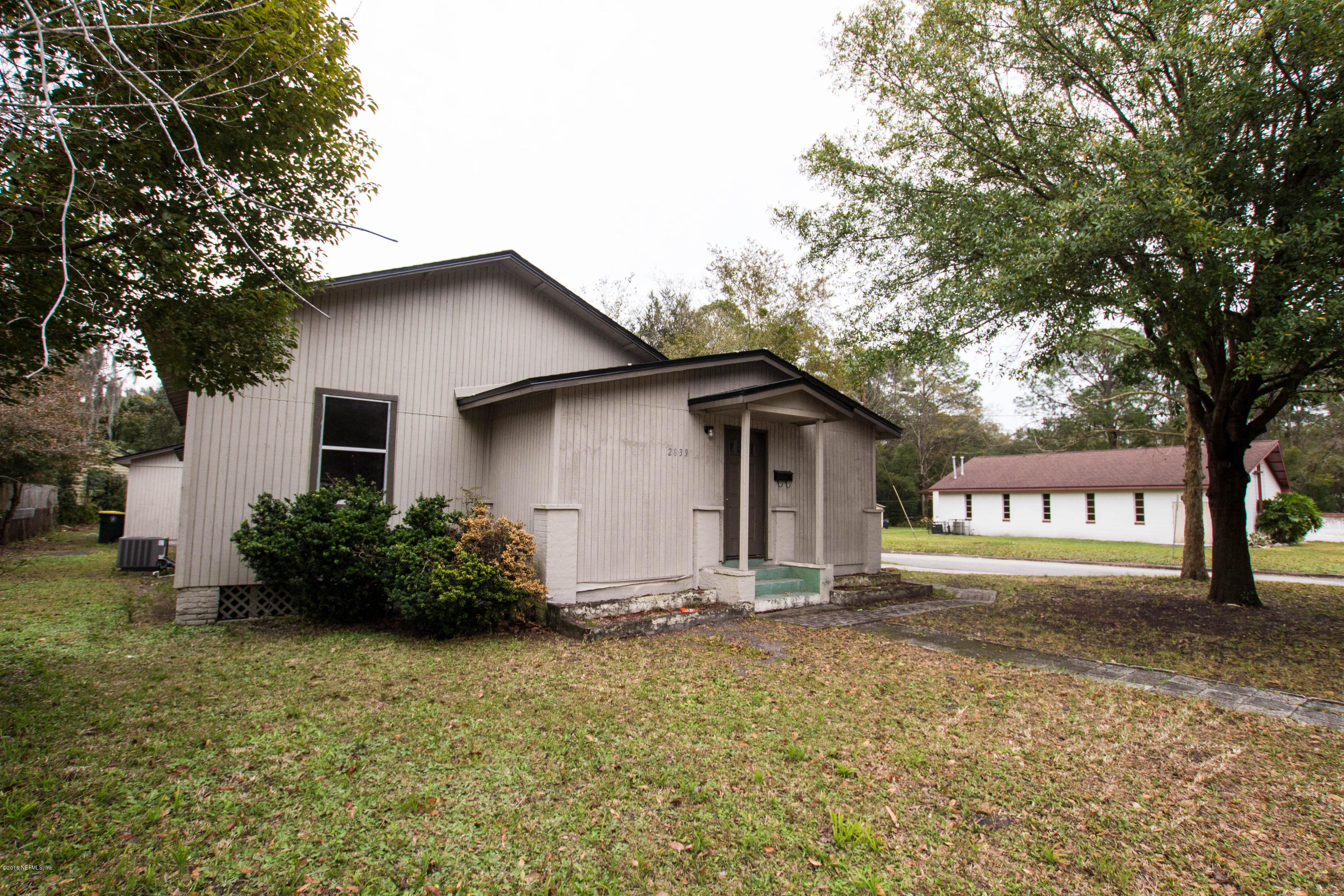 2839 Spring Park Road Jacksonville, FL 32207 - Photo 1 of 19 a front view of house with yard and trees around