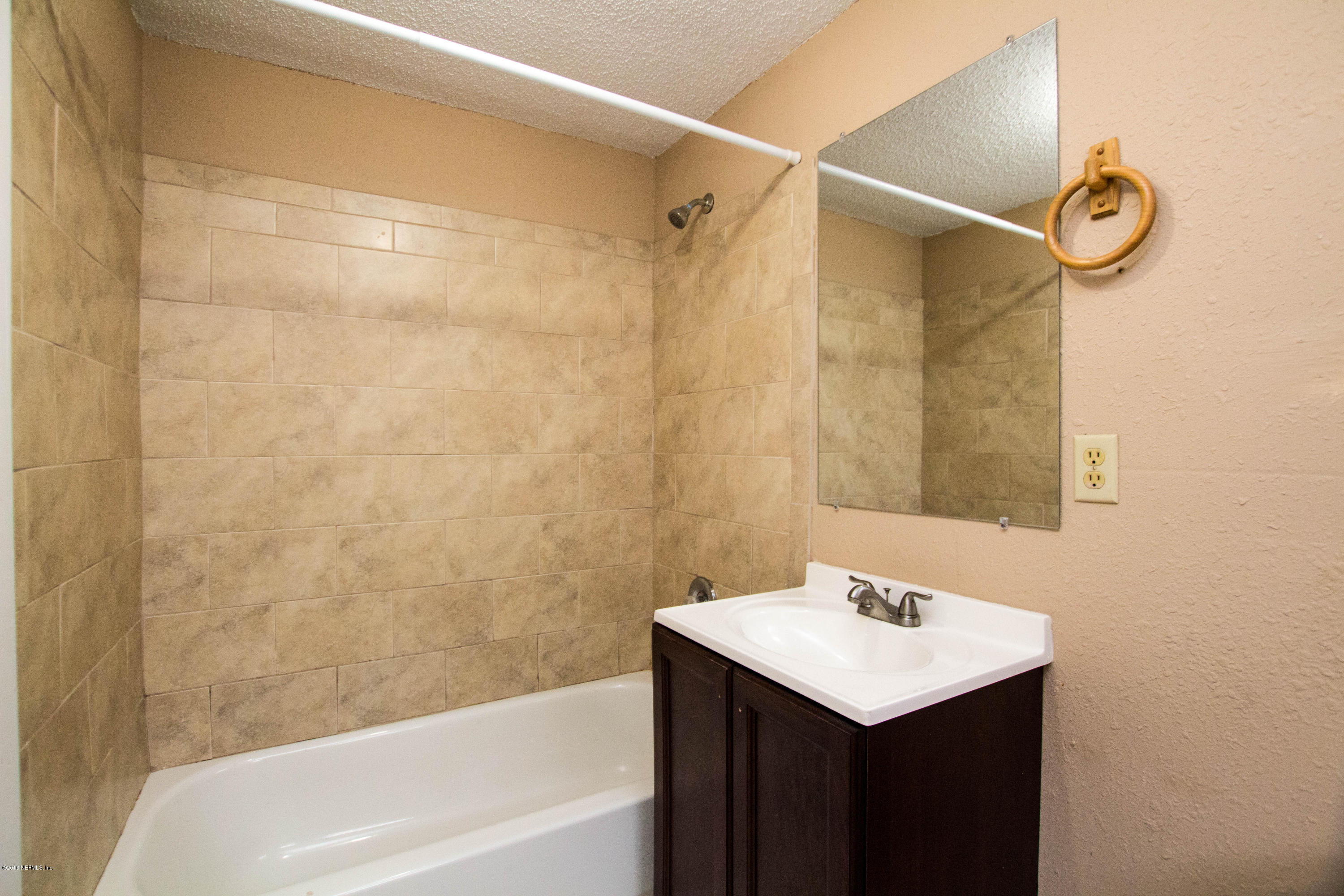 2839 Spring Park Road Jacksonville, FL 32207 - Photo 12 of 19 a bathroom with a sink shower and a bathtub