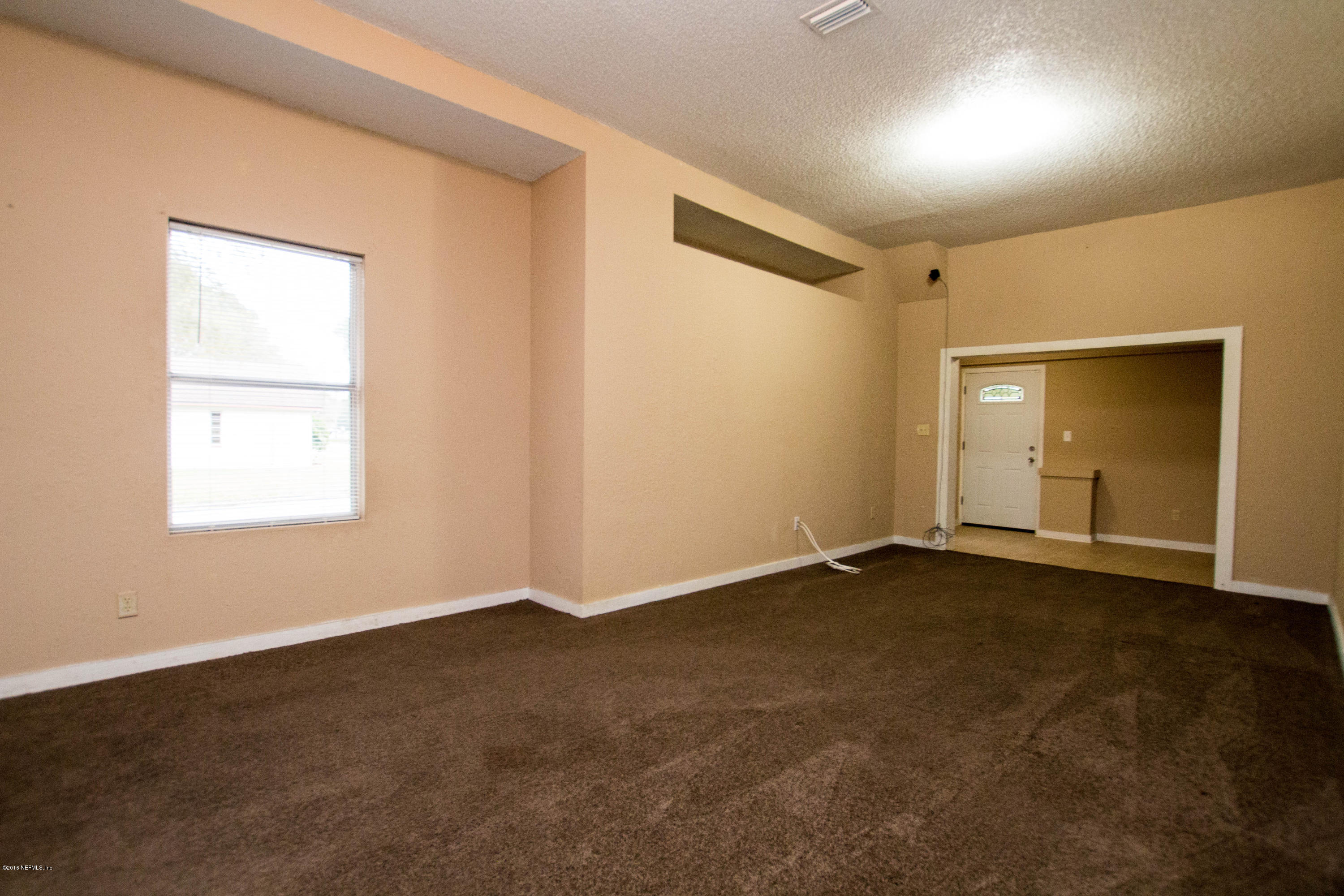 2839 Spring Park Road Jacksonville, FL 32207 - Photo 7 of 19 an empty room with a empty space and window