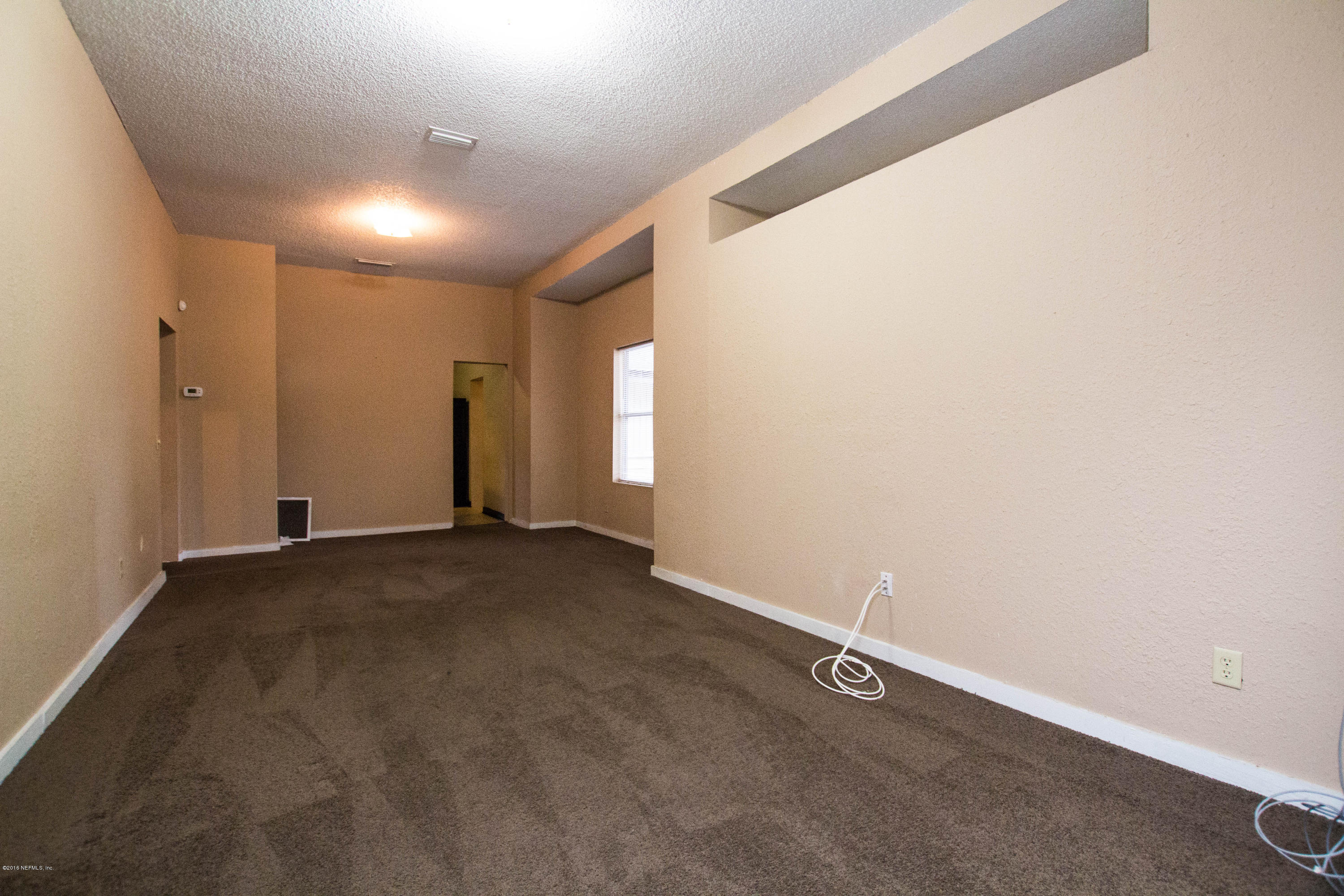 2839 Spring Park Road Jacksonville, FL 32207 - Photo 8 of 19 an empty room with windows