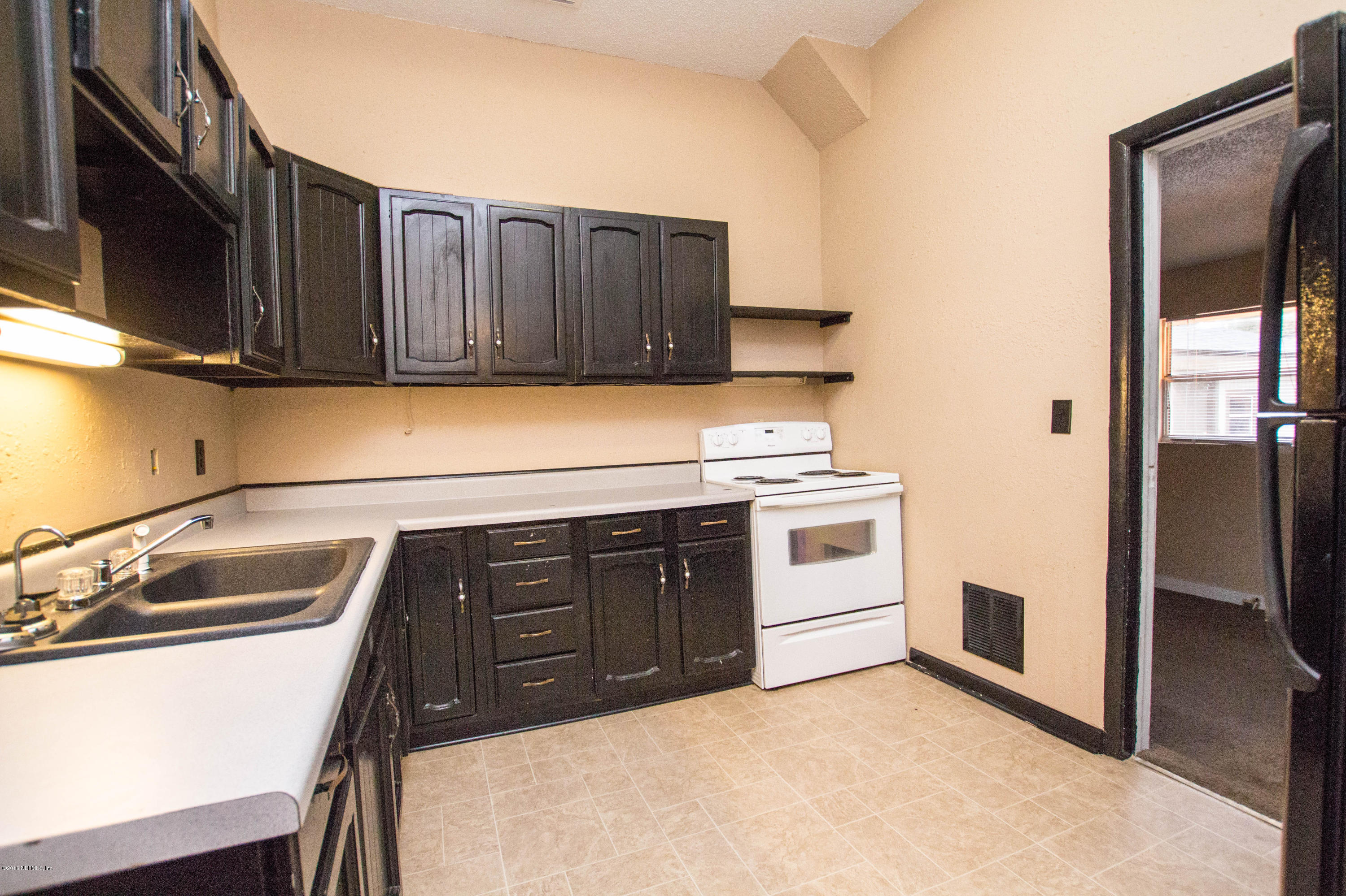 2839 Spring Park Road Jacksonville, FL 32207 - Photo 10 of 19 a kitchen with a sink cabinets and stainless steel appliances