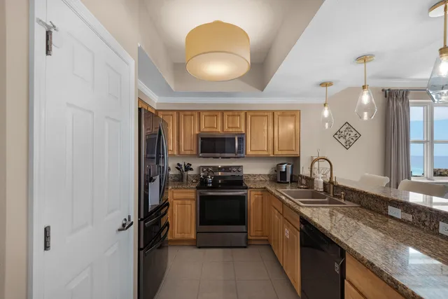 a kitchen with stainless steel appliances granite countertop a sink and a stove