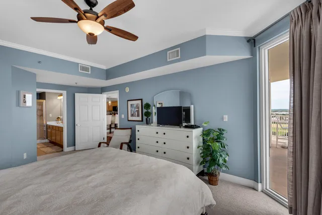 a bedroom with furniture a bed and a flat screen tv