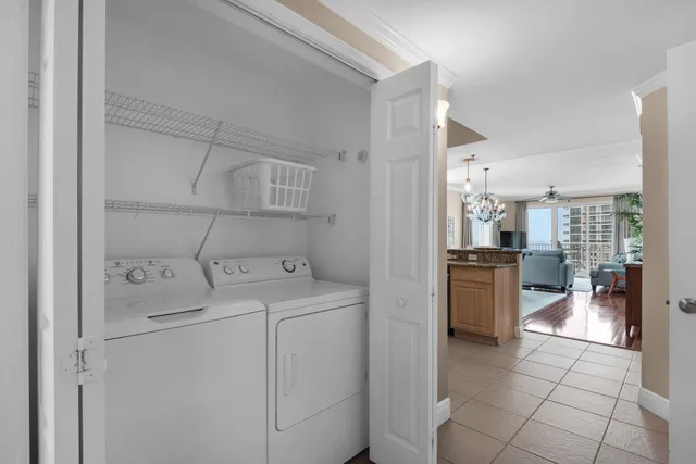 a bedroom with a bed and a flat tv screen on dresser