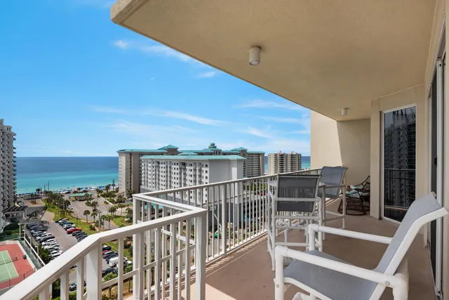 a view of a chairs and table in the balcony