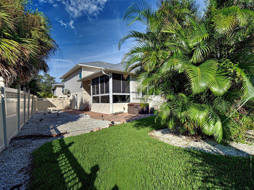 1801 Highland Road Osprey, FL 34229 - Photo 35 of 40 a view of a house with a yard and potted plants