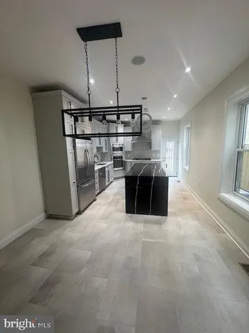 a lobby with furniture and a chandelier