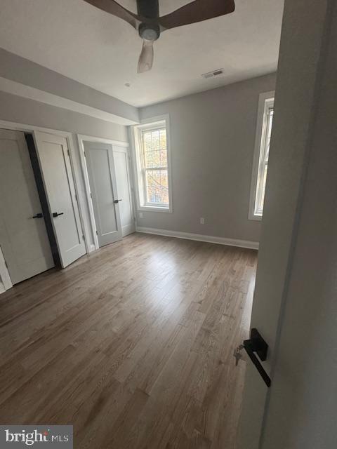 1809 Christian Street Philadelphia, PA 19146 - Photo 7 of 20 an empty room with wooden floor and windows