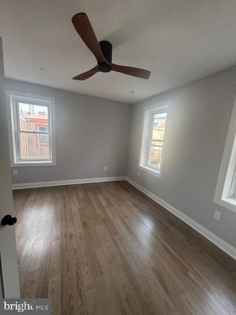 1809 Christian Street Philadelphia, PA 19146 - Photo 8 of 20 an empty room with wooden floor fan and windows
