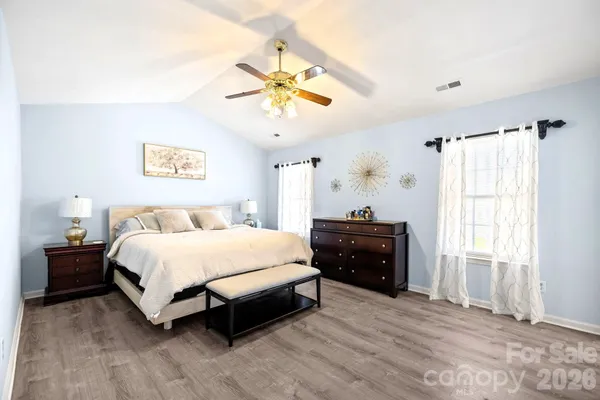 a spacious bedroom with a bed and a table in it