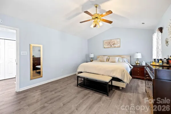 a spacious bathroom with a double vanity sink a large mirror and a shower