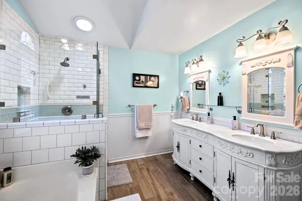 a spacious bathroom with a granite countertop sink a large mirror a toilet and a bathtub