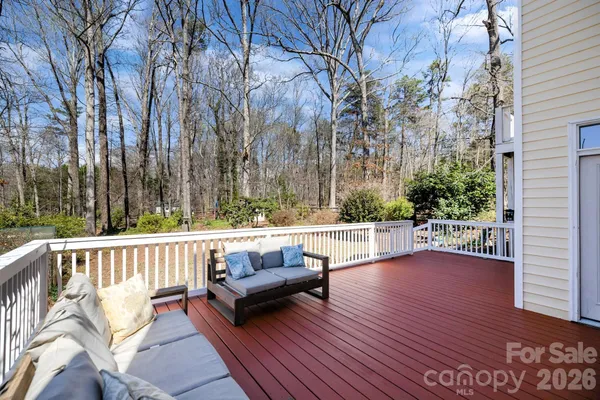 a view of wooden balcony and trees