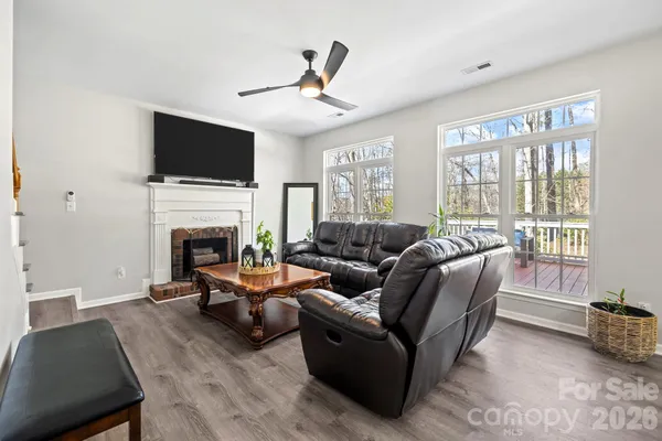 a living room with furniture fireplace and a flat screen tv