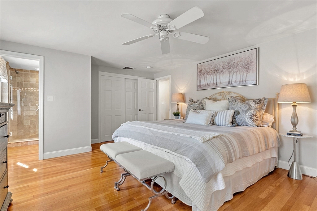 46 Wilmor Road Topsfield, MA 01983 - Photo 28 of 41 a spacious bedroom with a bed and a chandelier