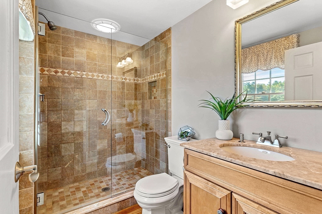 46 Wilmor Road Topsfield, MA 01983 - Photo 30 of 41 a bathroom with a granite countertop sink a toilet and shower