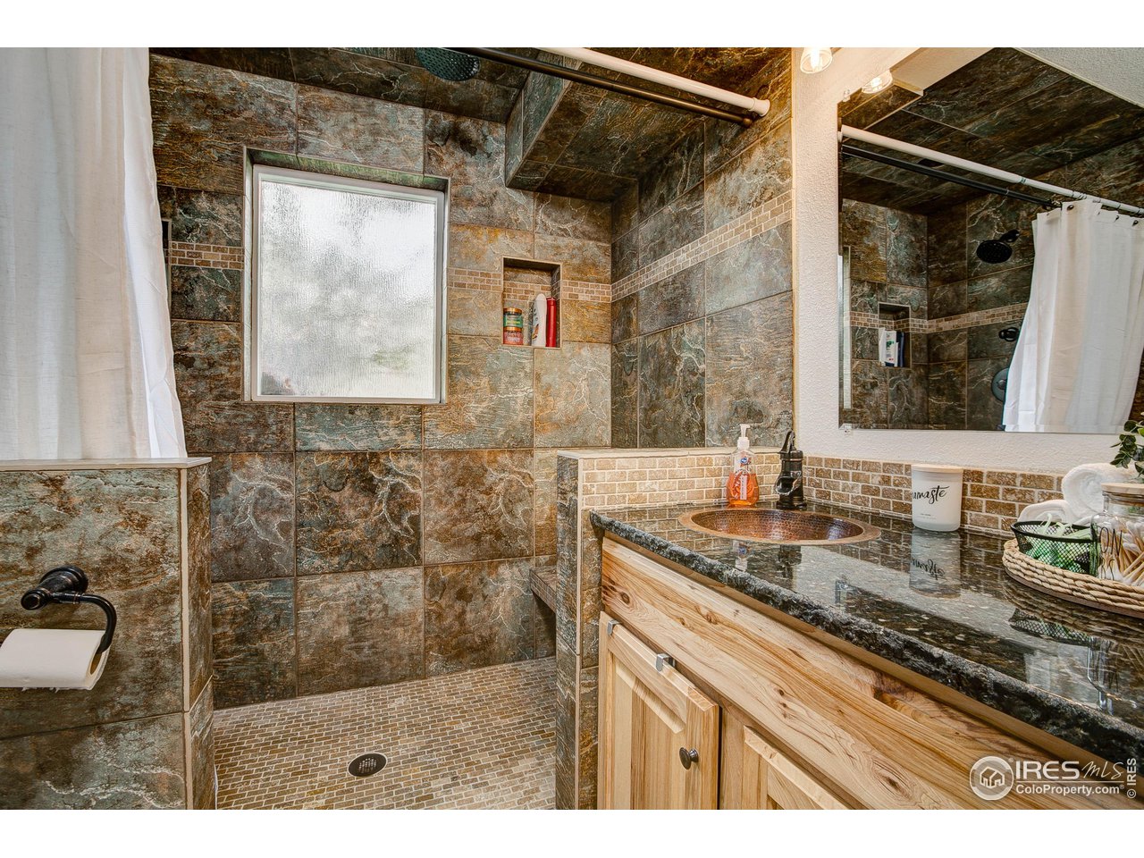 1912 Homestead Road Greeley, CO 80634 - Photo 32 of 40 Lower leve 3/4 bath with awesome walk in shower with custom tile work
