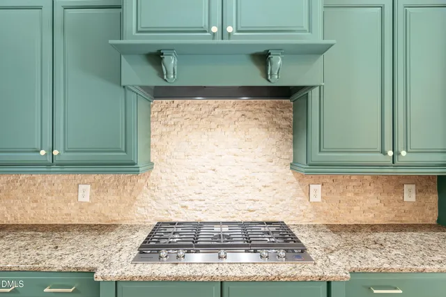a view of kitchen with granite countertop cabinets