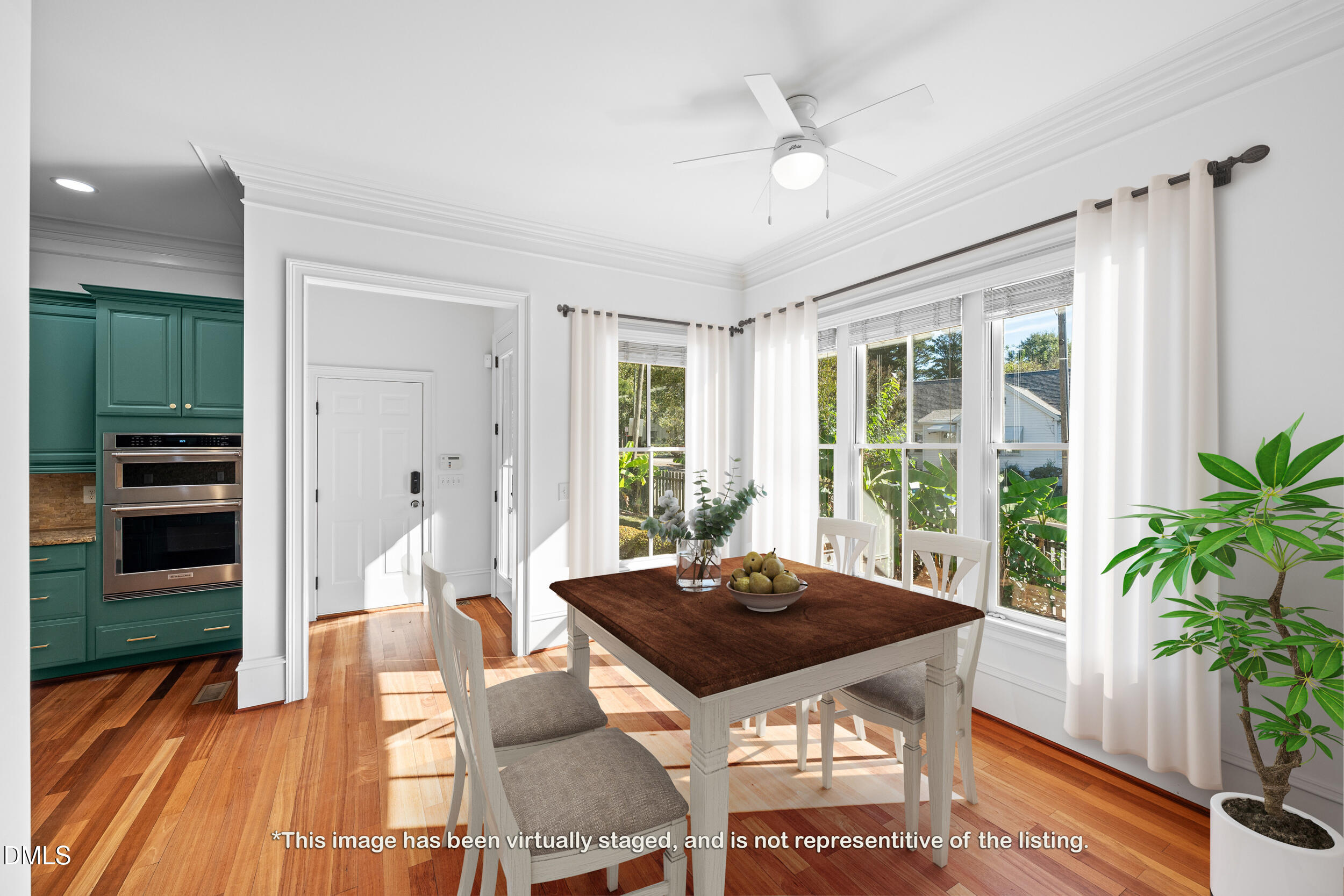 3100 Raymond Street Raleigh, NC 27607 - Photo 19 of 50 a view of a dining room with furniture window and wooden floor