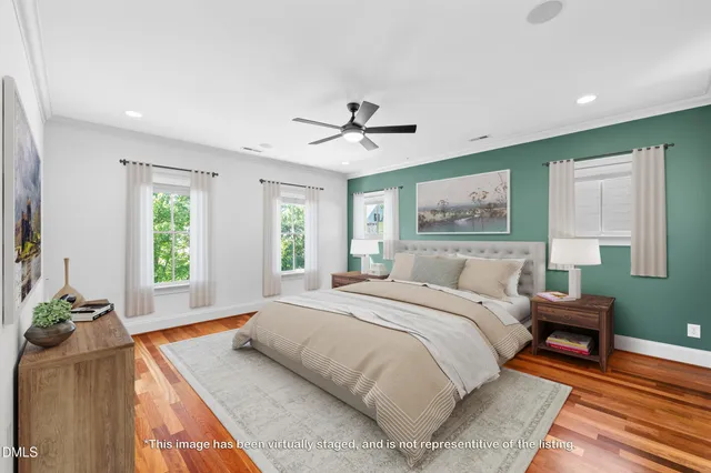 a spacious bedroom with a bed and a chandelier