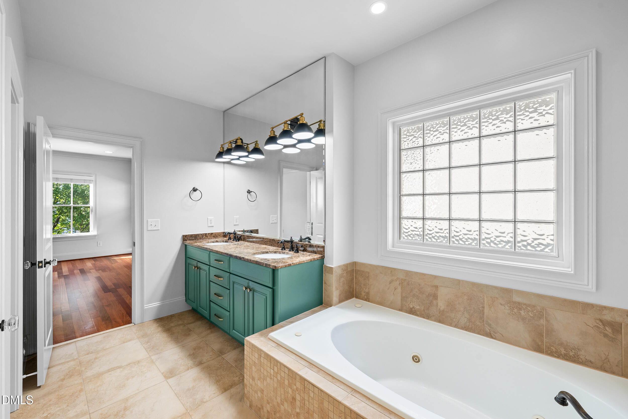 3100 Raymond Street Raleigh, NC 27607 - Photo 30 of 50 a bathroom with a tub sink and mirror