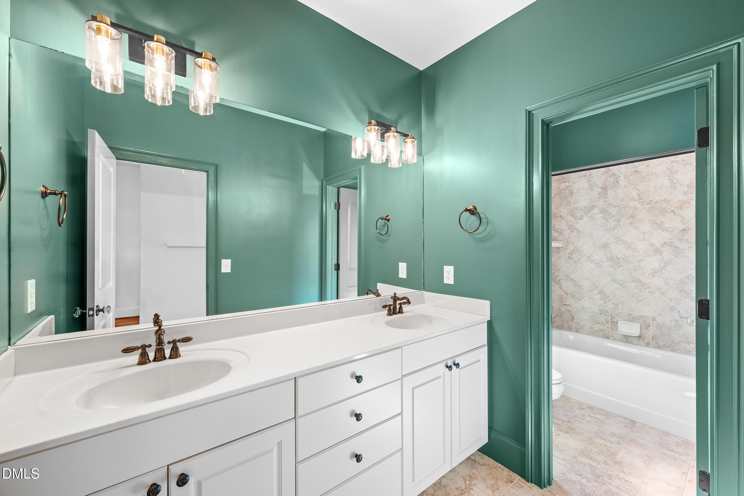 3100 Raymond Street Raleigh, NC 27607 - Photo 32 of 50 a bathroom with a double vanity sink and mirror