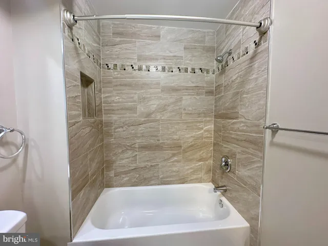 a bathroom with a shower and a toilet