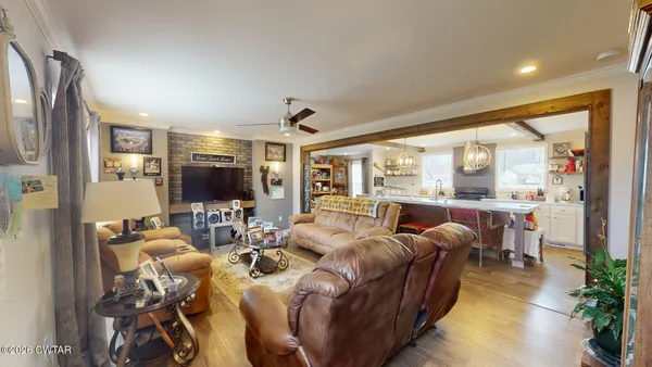 a living room with furniture large window and flat screen tv