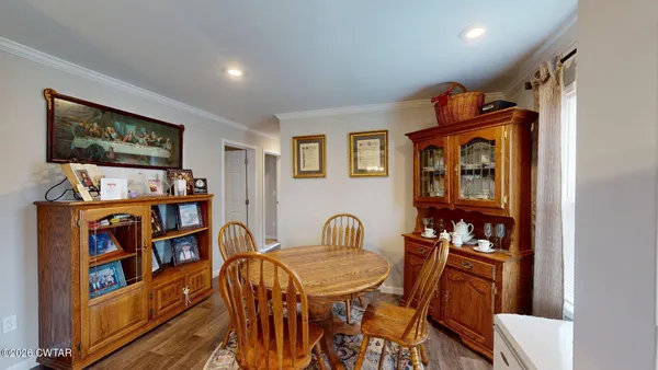 a dining room with furniture and a book shelf