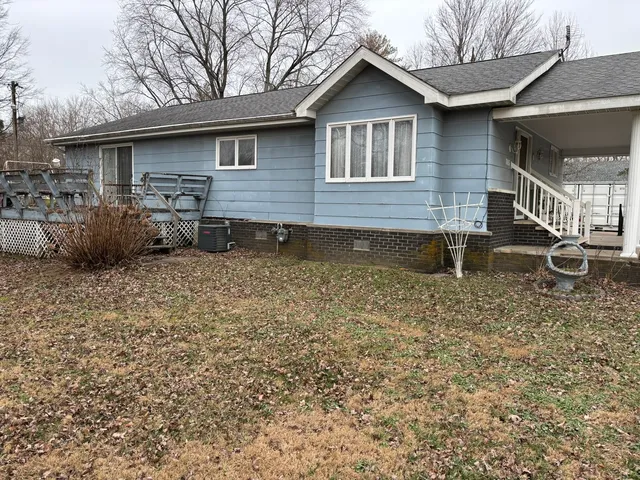 a backyard of a house with barbeque oven