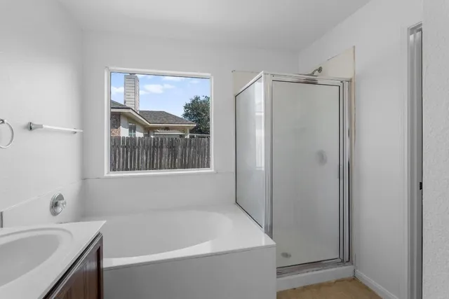 a bathroom with a tub and a sink