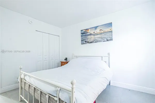 a bedroom with a bed and a wall painting