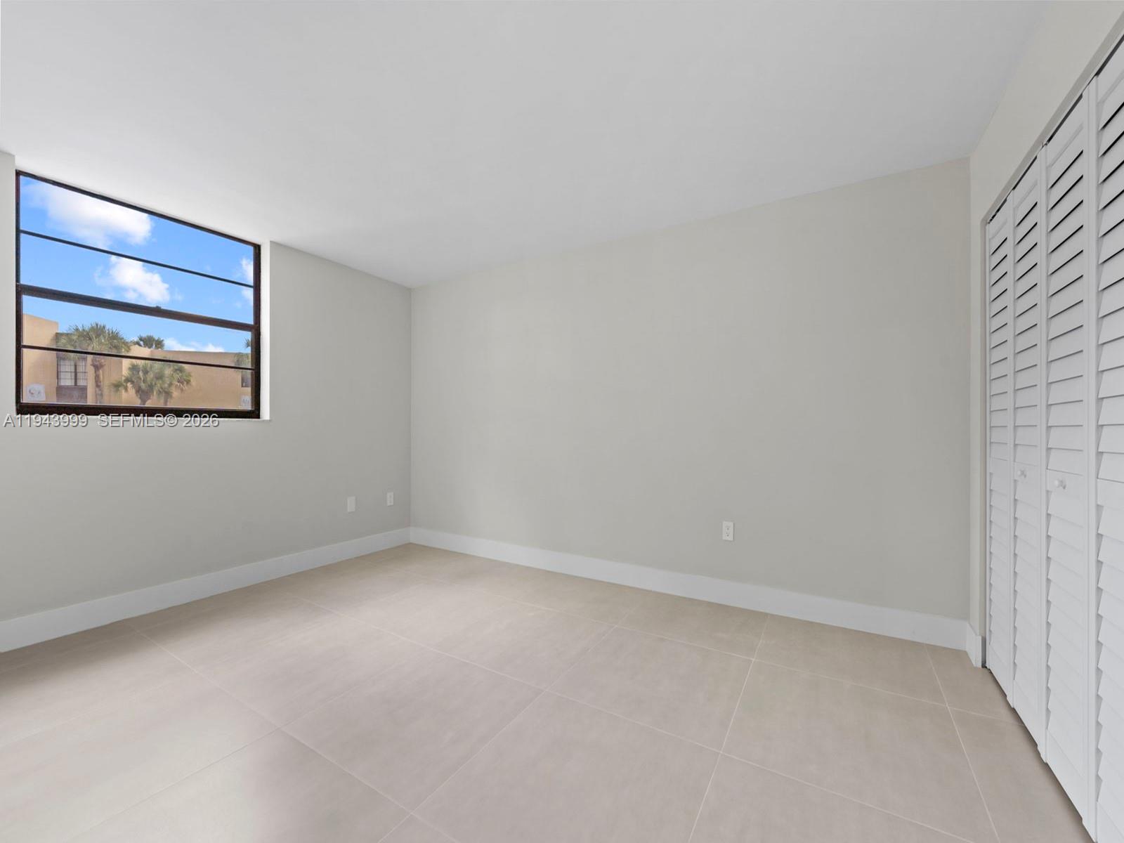 10825 Southwest 112th Avenue, Unit 206 Miami, FL 33176 - Photo 11 of 32 a view of an empty room with a window