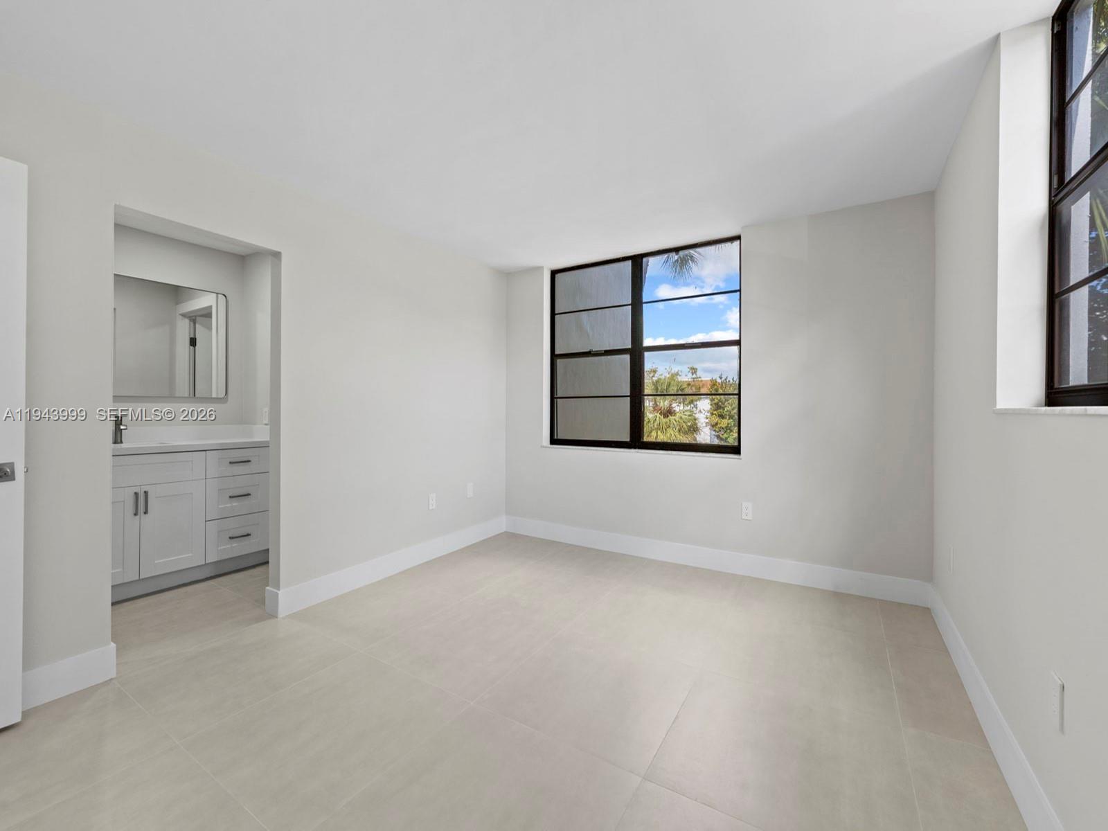 10825 Southwest 112th Avenue, Unit 206 Miami, FL 33176 - Photo 16 of 32 an empty room with windows and closet