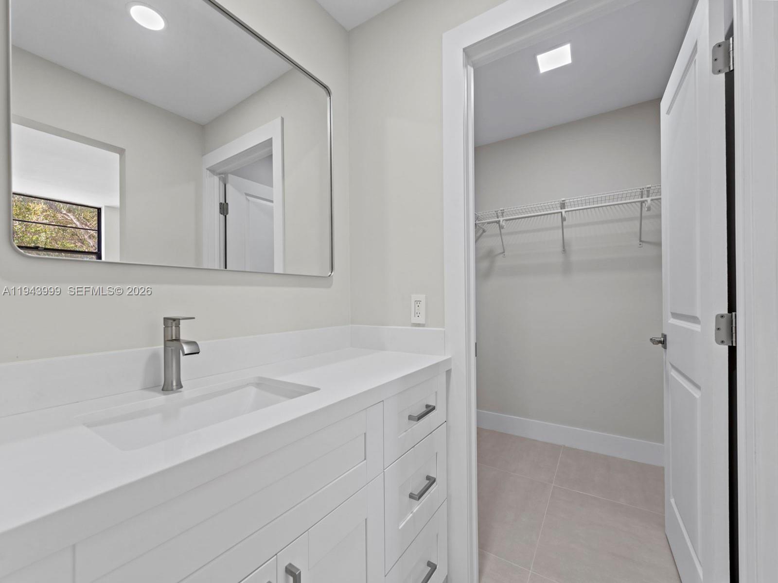 10825 Southwest 112th Avenue, Unit 206 Miami, FL 33176 - Photo 17 of 32 a bathroom with a sink and a mirror