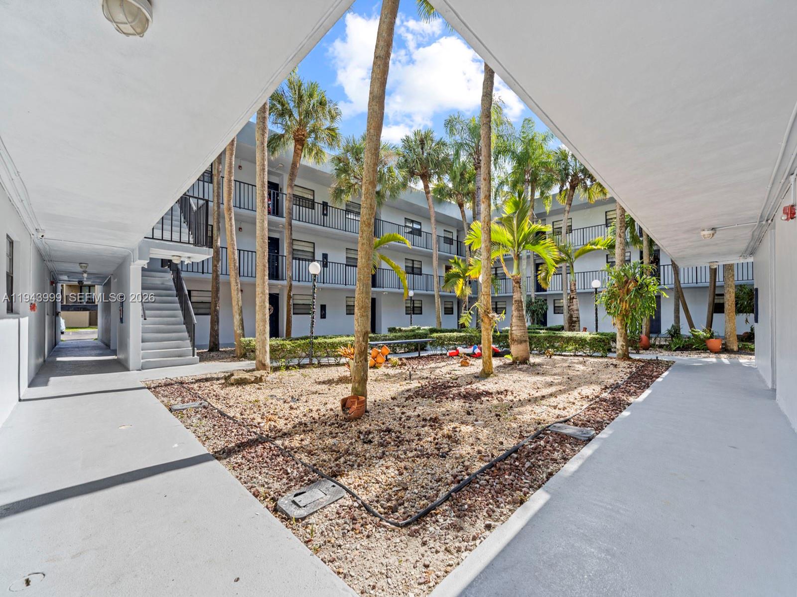 10825 Southwest 112th Avenue, Unit 206 Miami, FL 33176 - Photo 27 of 32 a building exterior with yard