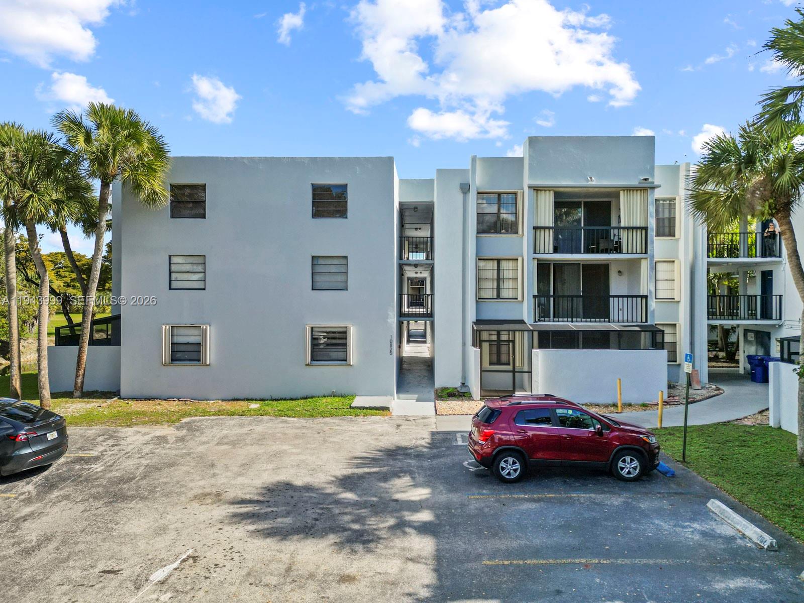 10825 Southwest 112th Avenue, Unit 206 Miami, FL 33176 - Photo 28 of 32 a car parked in front of a building