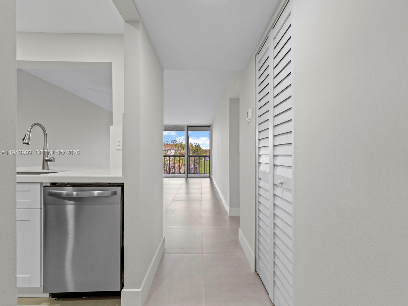 10825 Southwest 112th Avenue, Unit 206 Miami, FL 33176 - Photo 3 of 32 a view of a kitchen from the hallway with a sink