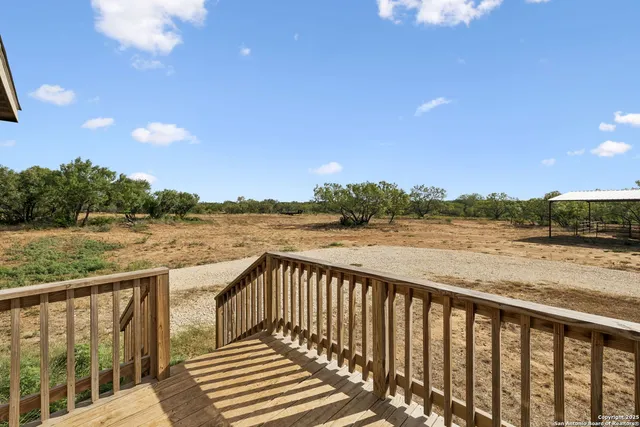 a balcony with wooden floor and lake view