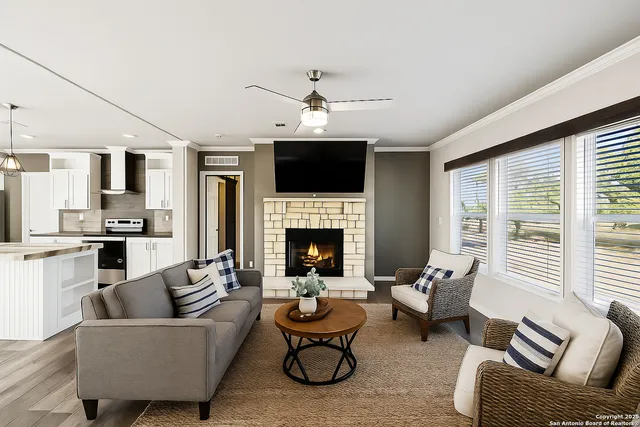 a living room with furniture fireplace and flat screen tv