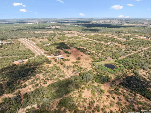 an aerial view of a house with a yard